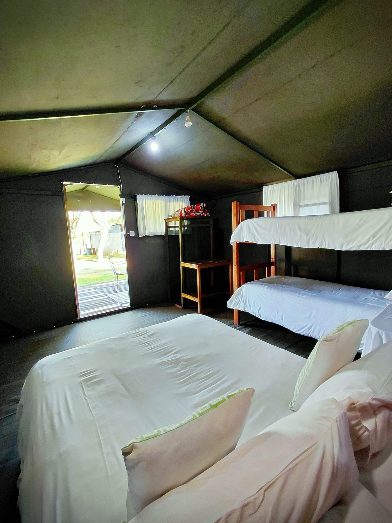 The four sleeper tent beds viewed from the back of the tent