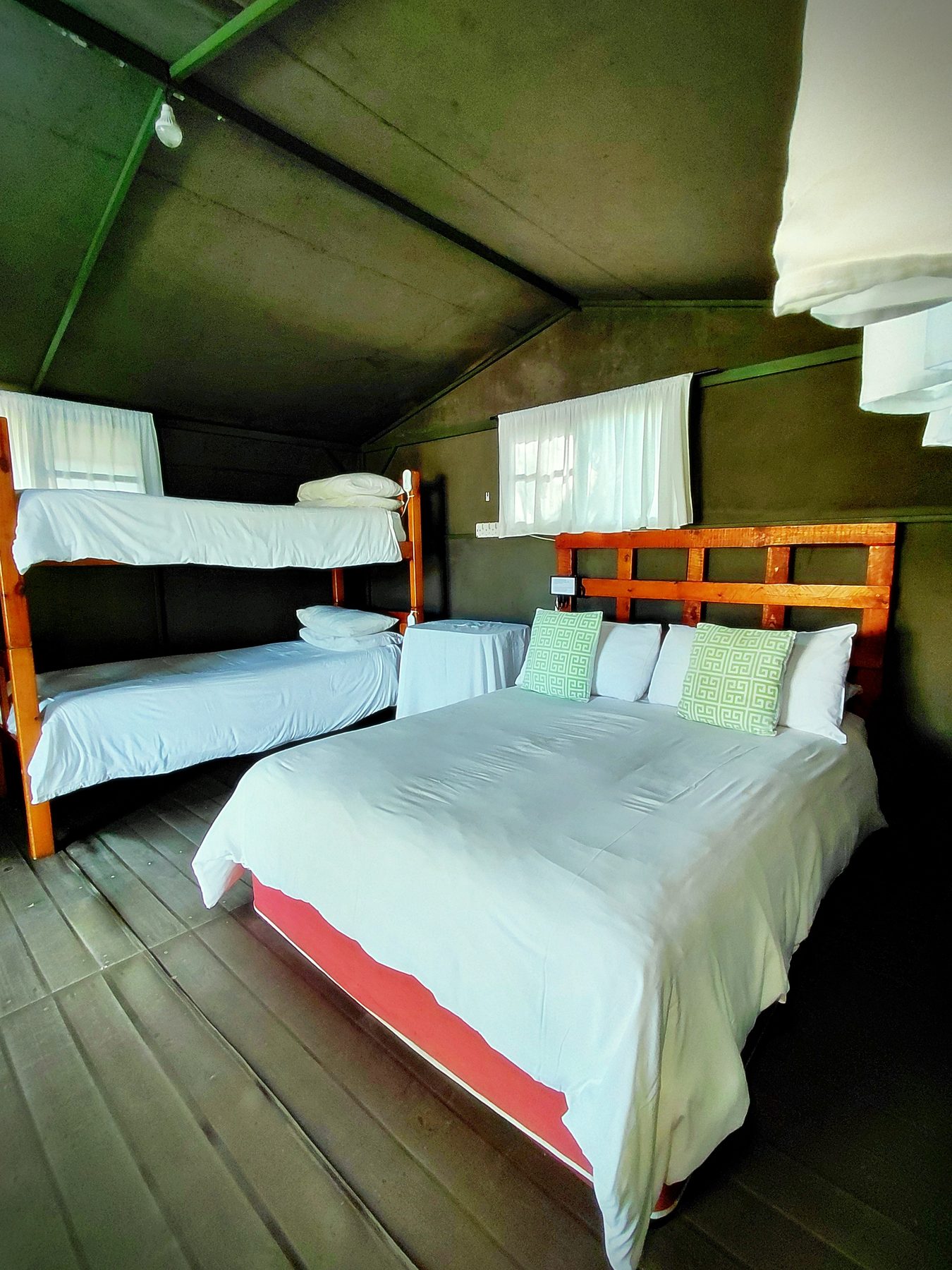 Beds made up with fresh linen inside a four sleeper tent